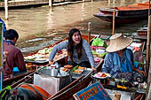 Thailand, Locals sell fruits, food and products at Damnoen Saduak floating market near Bangkok 